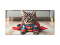 A canvas art piece featuring a cute cat dressed in a Superman costume with a cape, lying on a wooden floor.