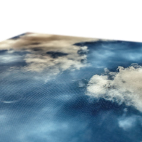 An area with an ocean and clouds on a surface.