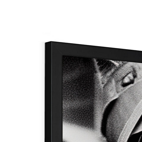 A flat screen TV is set on a black and white photo box.