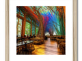 A table inside of an outdoor restaurant with a wall with colorful wood wood framed prints and