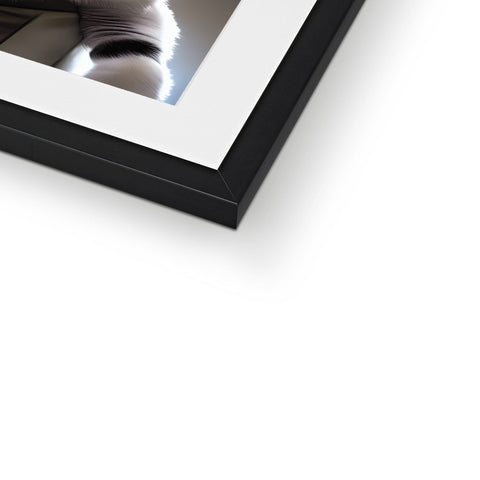 A picture frame in a white square picture frame with a reflection in it.