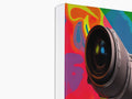 A camera on a softcover is looking through something looking into the eyes.
