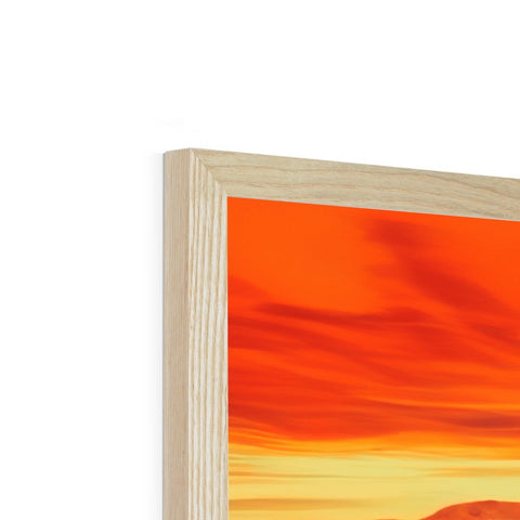 A wooden picture frame that matches a picture displayed on a wooden mantel.