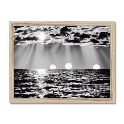 A picture frame with three pictures of an ocean on it with a sun with a sunset