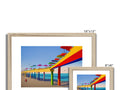 A photo with three colorful images on top of a wooden frame.