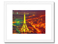 An art print of Paris next to the Eiffel Tower on a wooden frame.