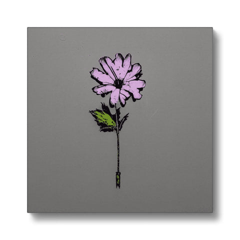 A flower stick with a little purple flower on a plate with white and pink flowers in