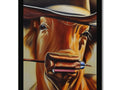 A cow looks into the eyes of a person wearing a cowboy hat.