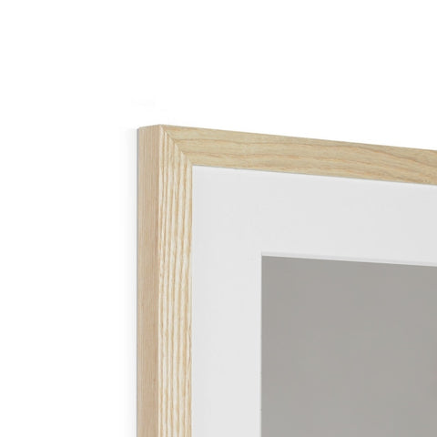 a white picture frame on top of a wall of a white wall on a hardwood