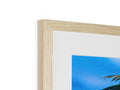 A picture frame with a small picture of a man posing on a beach.