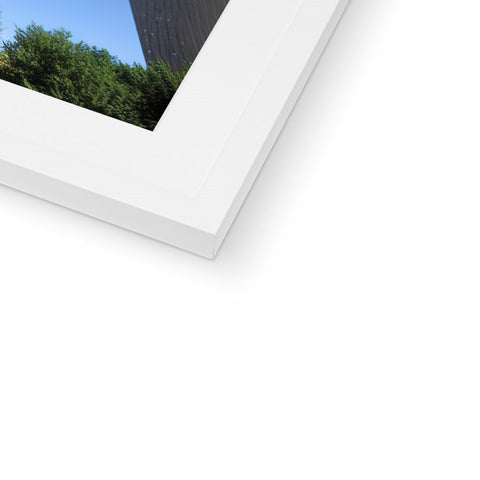A picture frame with one shot taken of a building in close-up.