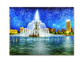 A place mats with a city skyline sitting on it near a fountain in the background of