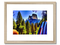 a framed artwork photo of a mountain in the middle of a forest with a mountain on