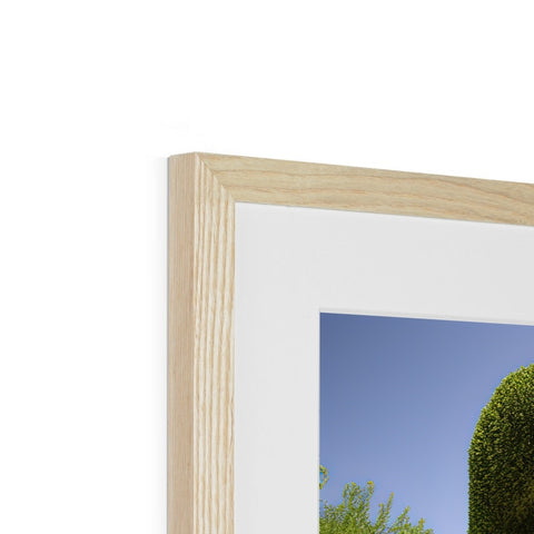 A picture frame with a framed picture of a tree upside down on the top of it