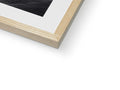 A picture of a white picture frame sitting on a table next to a wooden book.