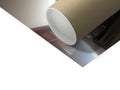 A small toilet roll on a roll holder underneath a picture of a toilet next to its