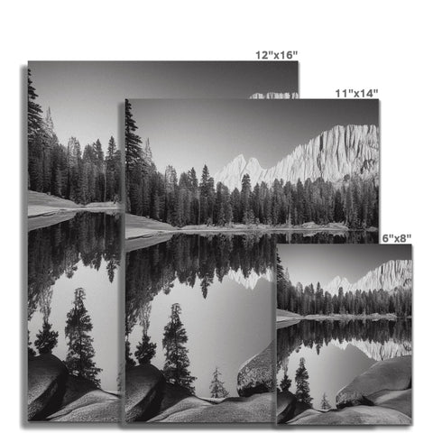 A picture of mountains and a lake in a black and white style picture frame.
