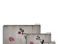 Black and white graffiti on a concrete wall with flowers on it.