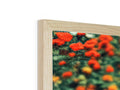 A rectangular picture frame has been wood covered in flowers, a cross section of trees,