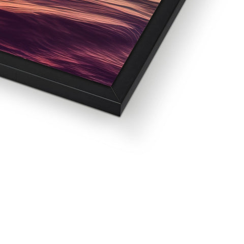 A picture frame sitting on top of a display screen on a tabletop.