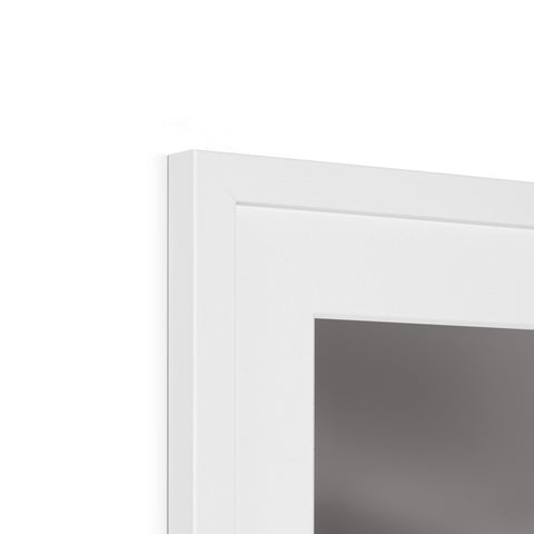 A picture frame is on top a wall above a white light switch inside a window.