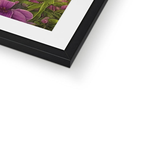 A large black picture frame with a picture of flowers on top and a white photo of