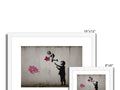 Two pictures of pictures of a floral arrangement on a white wall with art prints of flowers
