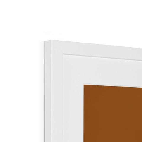 A brown and tan colored picture frame hanging on the wall of a mirror.