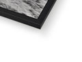 An abstract photograph in a frame hangs at the top of a flat television glass.