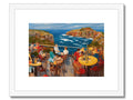 A picture of a beach beach by a table with colorful art prints on it.