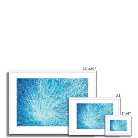 a picture frame with blue and white images of a white wall and a white glass window
