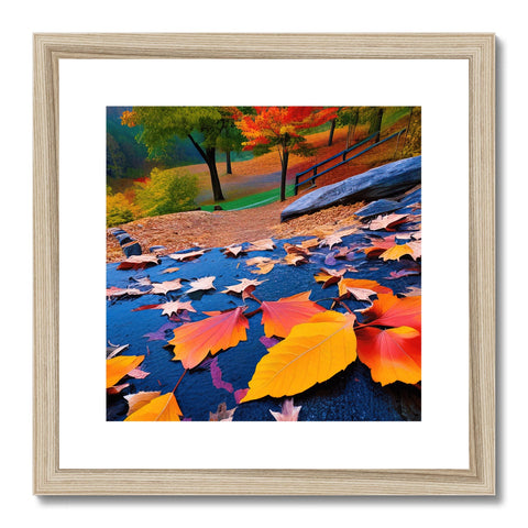 A framed art print of fall foliage and falling leaves.