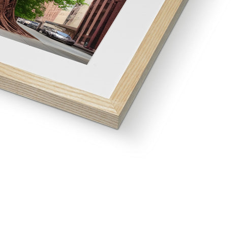 a picture frame with a view of a tree surrounded by a wood frame