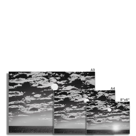 A calendar in black and white with a sky in a background.