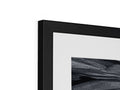A framed picture of a black and white picture sitting on top of a flat sheet tv