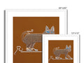 A soft brown cat sitting on a pile of white wall tiles with an art print on