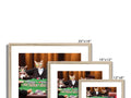 A picture frame with pictures of cats sitting at tables next to a small white tablecl
