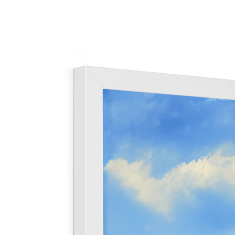 A small cloudy area with an imac on a white TV screen with clouds and blue