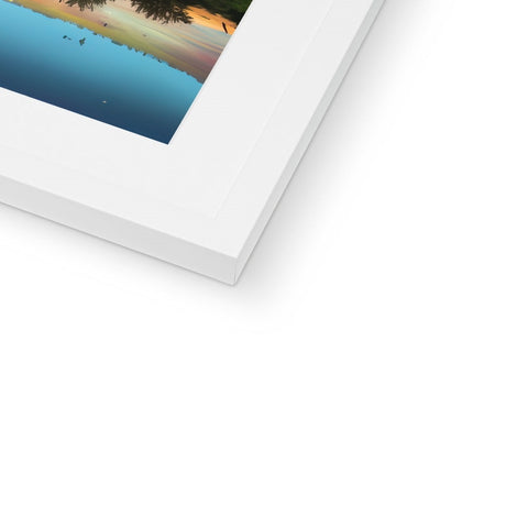 A picture frame with an Imac with a print next to several pictures.