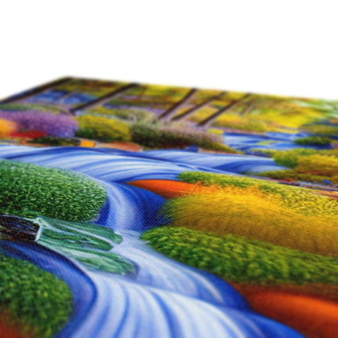 a place mat with colorful artwork on the front facing a view of a lake