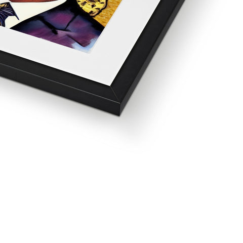 A hard glossy image of a photo on a metal frame lying on top of a book