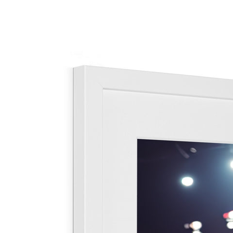 A large picture picture frame sitting on top of a wall surrounded in white lighting.