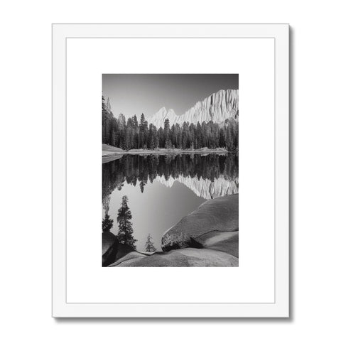 Art print sits next to a lake with snow covered mountains that look down upon the lake