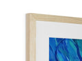 A wooden frame that has artwork on it with a blue mirror