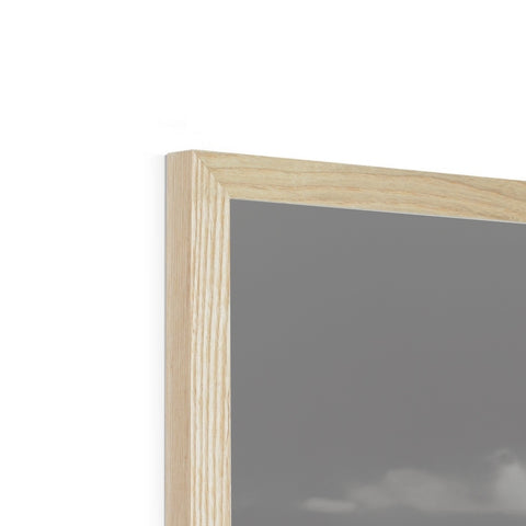 A piece of wood framed on a white table top on top of a picture frame.