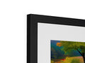 A very colorful picture framed in picture frame on a wall with art prints.