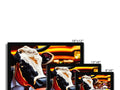 A cow standing in front of 4 monitors on a floor.