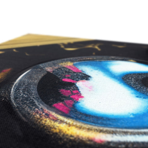 A photo of graffiti spray painting on a CD case with silver foil.