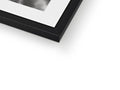Three photos in a picture frame holding a large photo on a black and white shelf.
