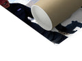 A white, rectangular roll of toilet trash off of a roll, rolling in the palm